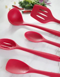 Close-up detail of red silicone kitchen cooking utensils set, featuring spatula and spoon tools.