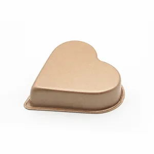 Golden heart-shaped non-stick carbon steel baking pan for small cakes, puddings, and muffins.