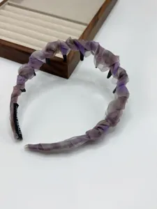 Close-up detail of the purple organza pleated headband, showing the soft fabric and inner teeth.