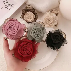 Detail view of the elegant fabric rose hair claw clip showcasing fine mesh flower texture.