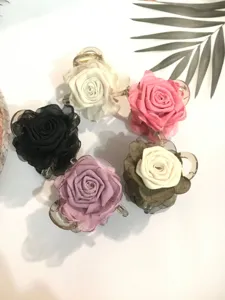 Detail view of elegant organza rose flower hair claw clips, perfect for stylish half-up hairstyles.