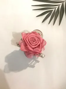 Silk rose flower hair claw clip detail close-up, elegant pink hair accessory for women styling.