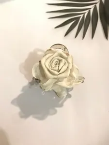 Detail view of the elegant beige fabric rose flower hair claw clip, perfect for stylish half-tied hair.