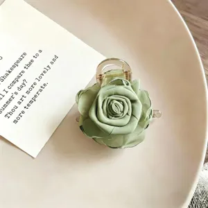 Green fabric rose hair claw clip detail, elegant floral hair accessory for women half updo.