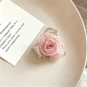Elegant pink organza rose flower hair claw clip, chic hair styling accessory for women.