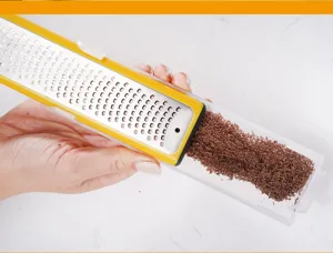 Detail shot of multi functional cheese grater featuring a clear container and protective cover.