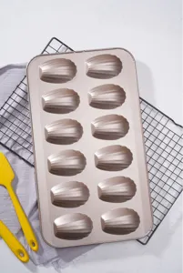 Detailed view of the gold non-stick 12-cavity Madeleine baking pan for home baking cakes.