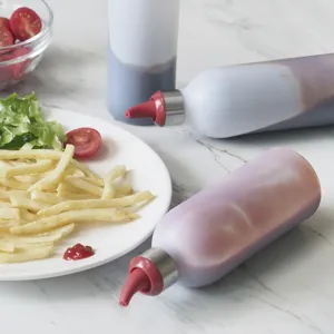 Squeeze bottles for kitchen condiments, plastic sauce dispensers with red nozzle caps.