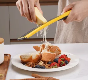 Multifunctional cheese grater with yellow handle for grating cheese and lemon zest