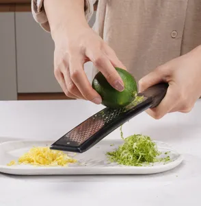 Stainless steel lemon zester and cheese grater detail showing practical kitchen use.