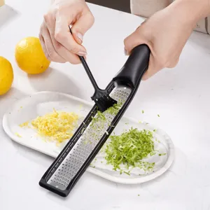 Multi-functional kitchen lemon zester and cheese grater with ergonomic handle for easy cooking.