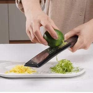 Stainless steel citrus zester and cheese grater with comfortable handle for kitchen use.