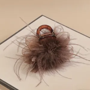 Elegant brown feather hair claw clip for women, stylish updo hair accessory for daily wear.