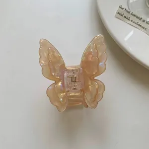 Detail view of the translucent acetate butterfly hair claw clip, featuring delicate texture.