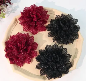 Detailed shot of large glitter fabric flower hair accessories, DIY craft materials, close-up.