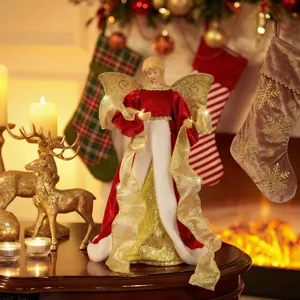 Detailed close-up shot of the elegant Christmas tree topper angel figurine in festive red and gold.