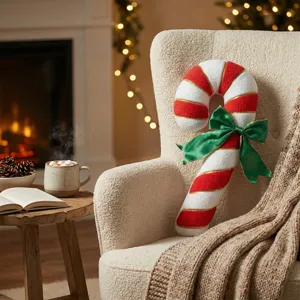 Cozy plush candy cane throw pillow with green bow, perfect for festive holiday home decor.