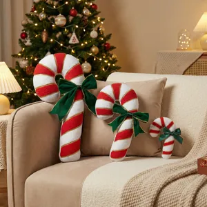 Christmas candy cane plush throw pillows set with green bows for cozy holiday home sofa decor.