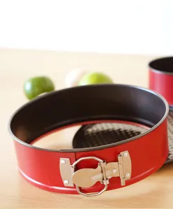 Red 10-inch springform cake pan detail, showcasing non-stick carbon steel baking mold texture.