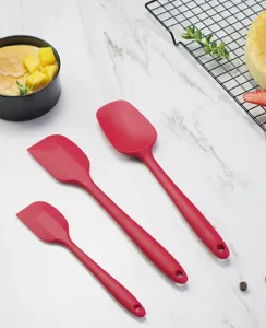 Silicone cream spatula set for baking, red integrated design with hanging hole for easy kitchen storage.