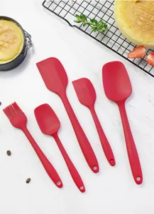Detailed view of red silicone baking spatulas showing flexible texture and smooth surface design.