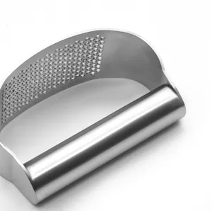 Stainless steel garlic press detail view showing dense piercing holes and curved ergonomic handle.