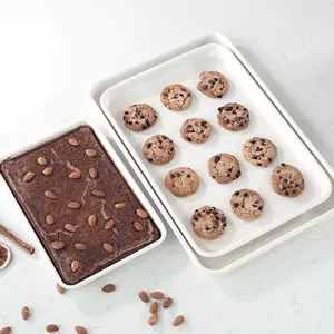 Rectangular carbon steel baking pan set for cookies and cakes, white kitchen bakeware tool.