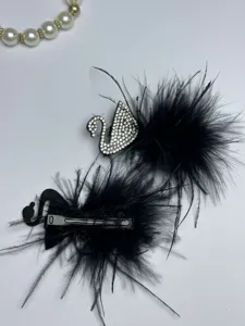 Black feather hair clip with crystal swan design, elegant hair accessory for women.