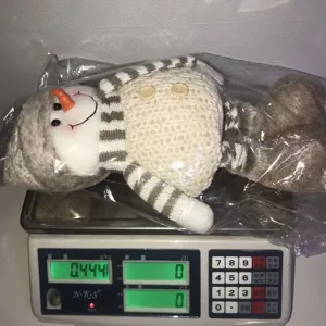 Christmas plush snowman doll with knitted hat and telescopic legs for holiday decoration.