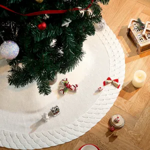 White knitted Christmas tree skirt for holiday home decor, soft woven fabric tree mat.