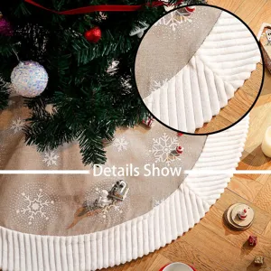 Detailed view of the Christmas tree skirt, burlap fabric with white snowflakes and plush ruffle.