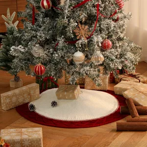 Knitted Christmas tree skirt with red border and white center, festive holiday decor.