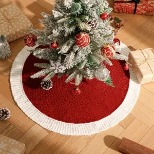 Detailed close-up of the red and white knitted Christmas tree skirt in festive scene.