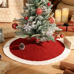 Detailed shot of knitted red and white Christmas tree skirt in a festive holiday scene setup.