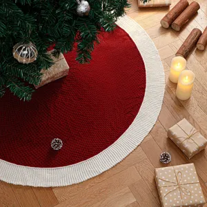 Cozy red and white knitted Christmas tree skirt detail, festive holiday home decor item.