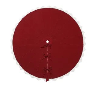 Knitted Christmas tree skirt with festive red and white scalloped edge design for holiday decor.