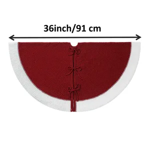 Red knitted Christmas tree skirt with white border and bows, detailed 36 inch holiday decor.