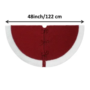 Detailed view of the 48 inch knitted Christmas tree skirt with red body, white border and bows.