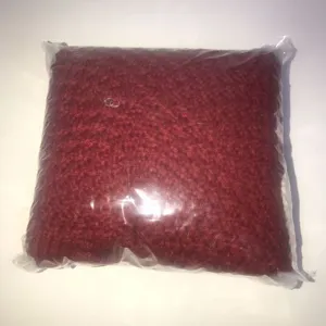 Dark red knitted textile item in a clear protective bag, simple daily essential for cozy home decor.