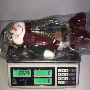 Christmas snowman telescopic plush doll detail view, showing weight measurement on electronic scale.