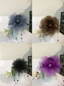 Detailed view of large mesh flower hair claw clip with pearl tassel, multi-color variant display.