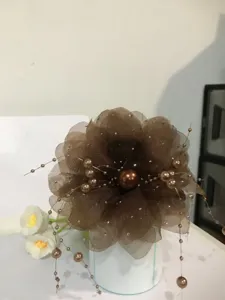Brown mesh peony flower hair claw clip with elegant pearl beaded tassel detail closeup view.