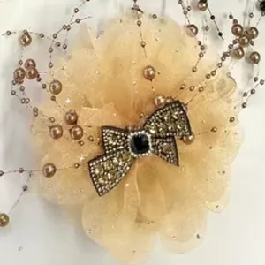 Exquisite champagne mesh peony hair clip detail, featuring sparkling rhinestones and beaded fringe.