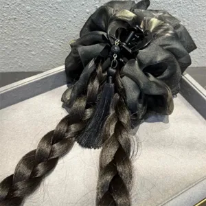 Close-up detail view of the new Chinese style black braided hair claw clip with delicate tassel.