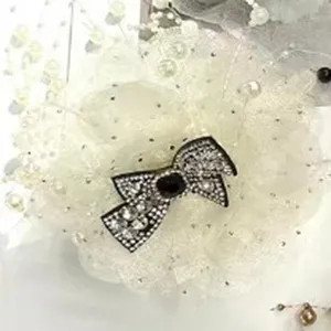 Detailed view of the elegant autumn winter peony hair claw clip with dazzling crystal bow and pearls.
