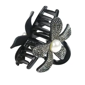 Rhinestone flower hair claw detail view with faux pearl accent and black velvet petals.