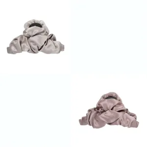 Detailed shot of large fabric hair claw, stylish pleated design for elegant hairstyles.
