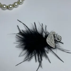 Elegant black feather hair clip with rhinestone swan detail, perfect for stylish daily wear.