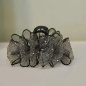 Detailed view of the black mesh hair claw clip with glitter organza design for styling.