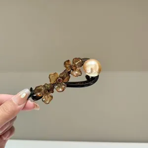 Detailed close-up of retro acetate flower hairpin with faux pearl and crystal details.